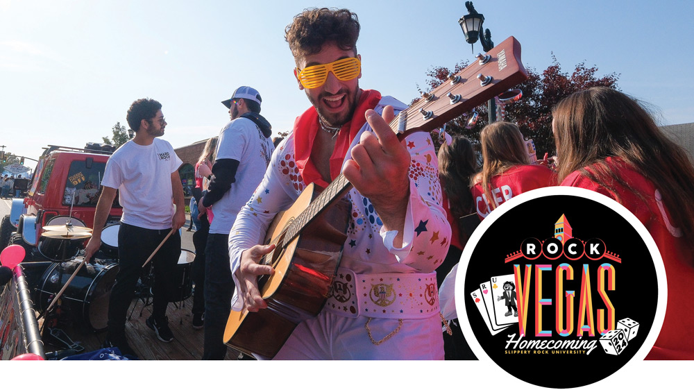 man dressed as Elvis playing an acoustic guitar