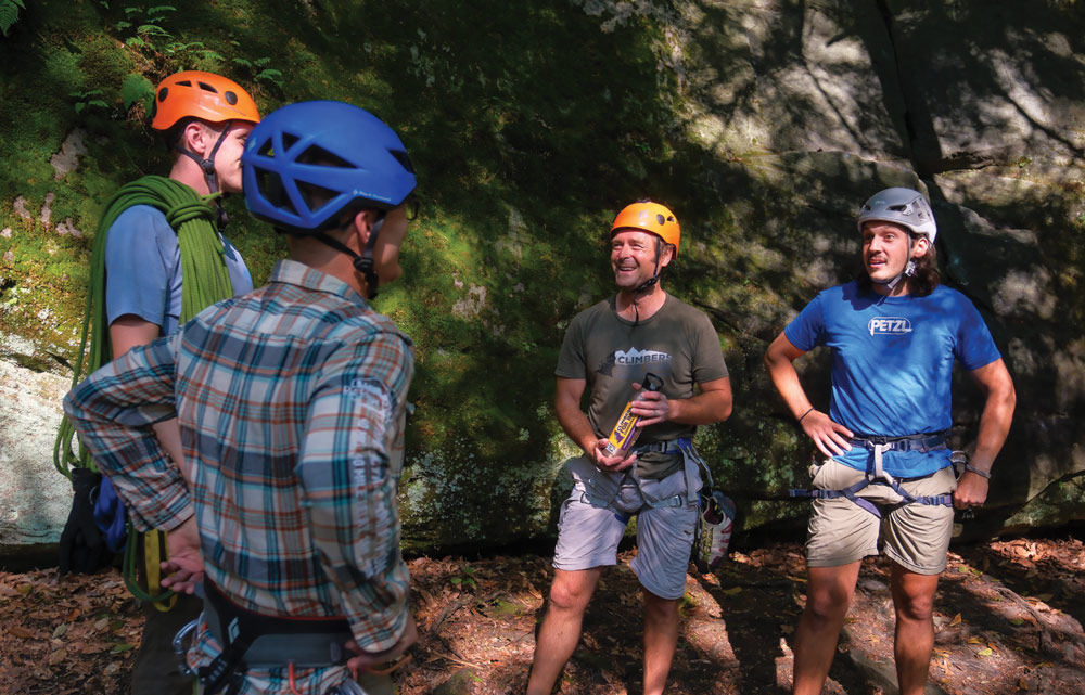 group of climbers having a conversation while wearing their gear