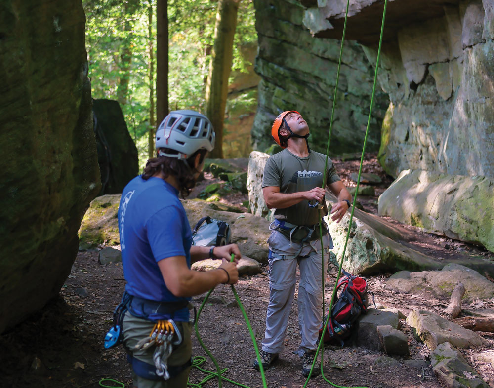 Alex Witmer and Sean Davis prepping rope cliffside to prepare for a climb