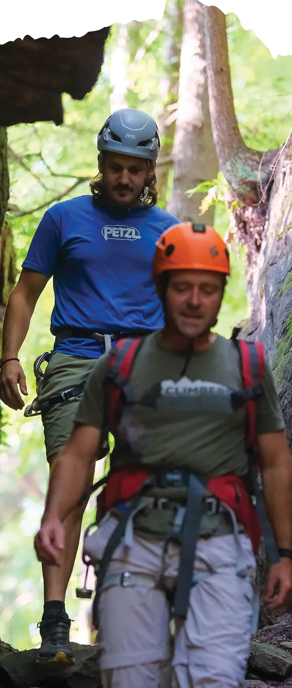 Alex Witmer and Sean Davis walking on a trailer in their climbing gear