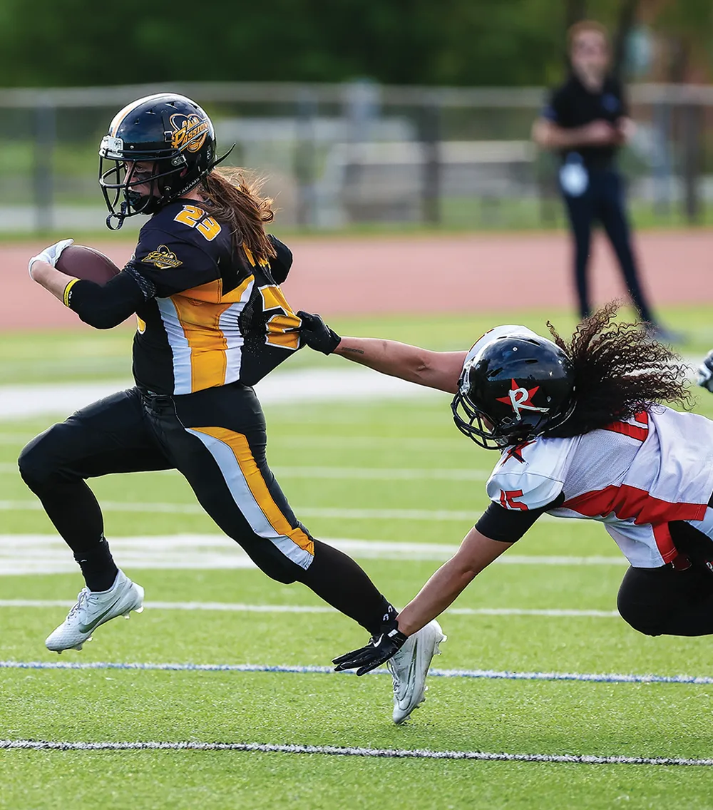 Devon Peace breaking a tackle while running the football for Pittsburgh Passion