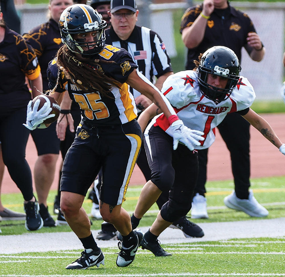 Jana Meister of the Pittsburgh Passion next to her opponent after making a catch