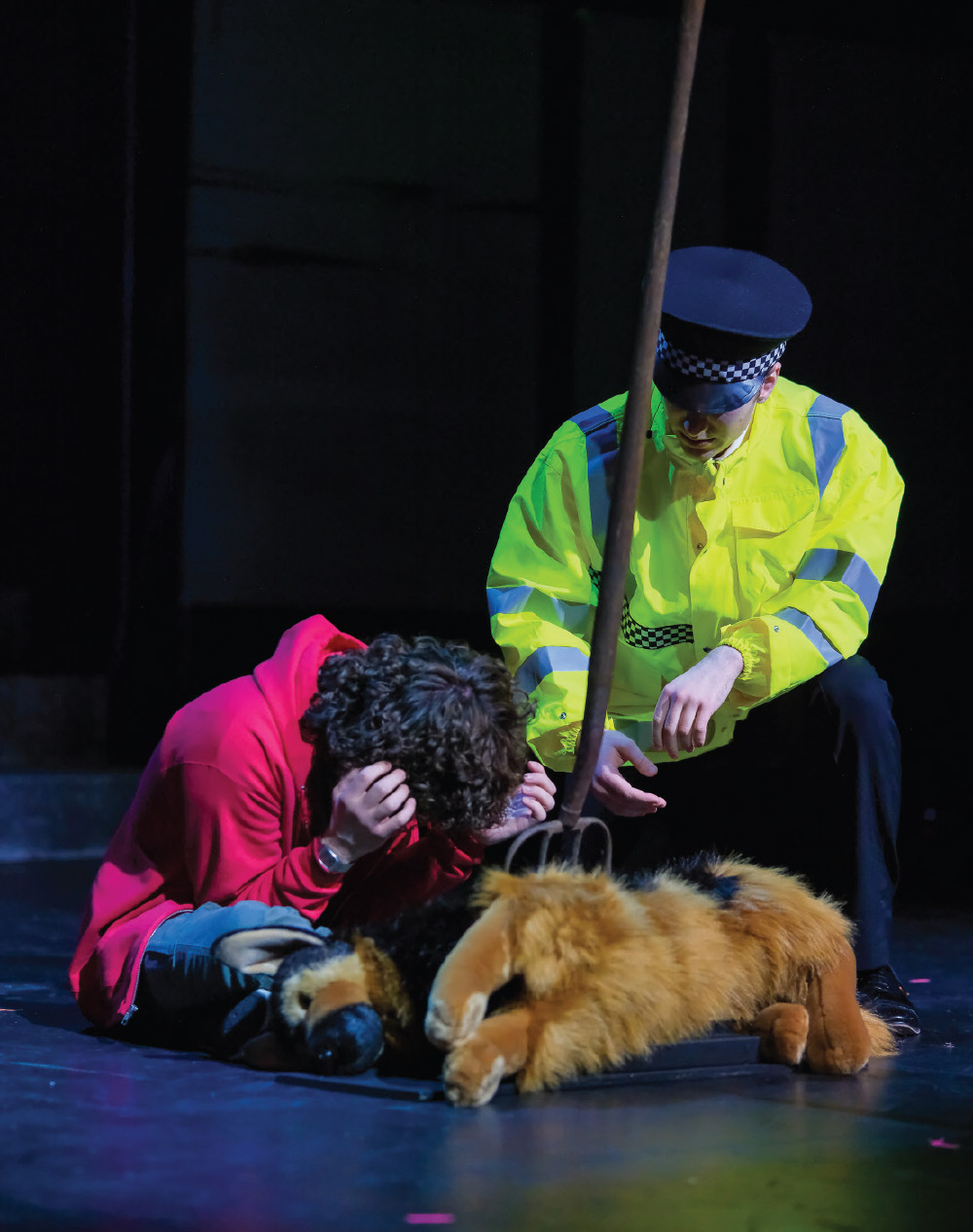 English police officer uniform and a stuffed dog being used on stage