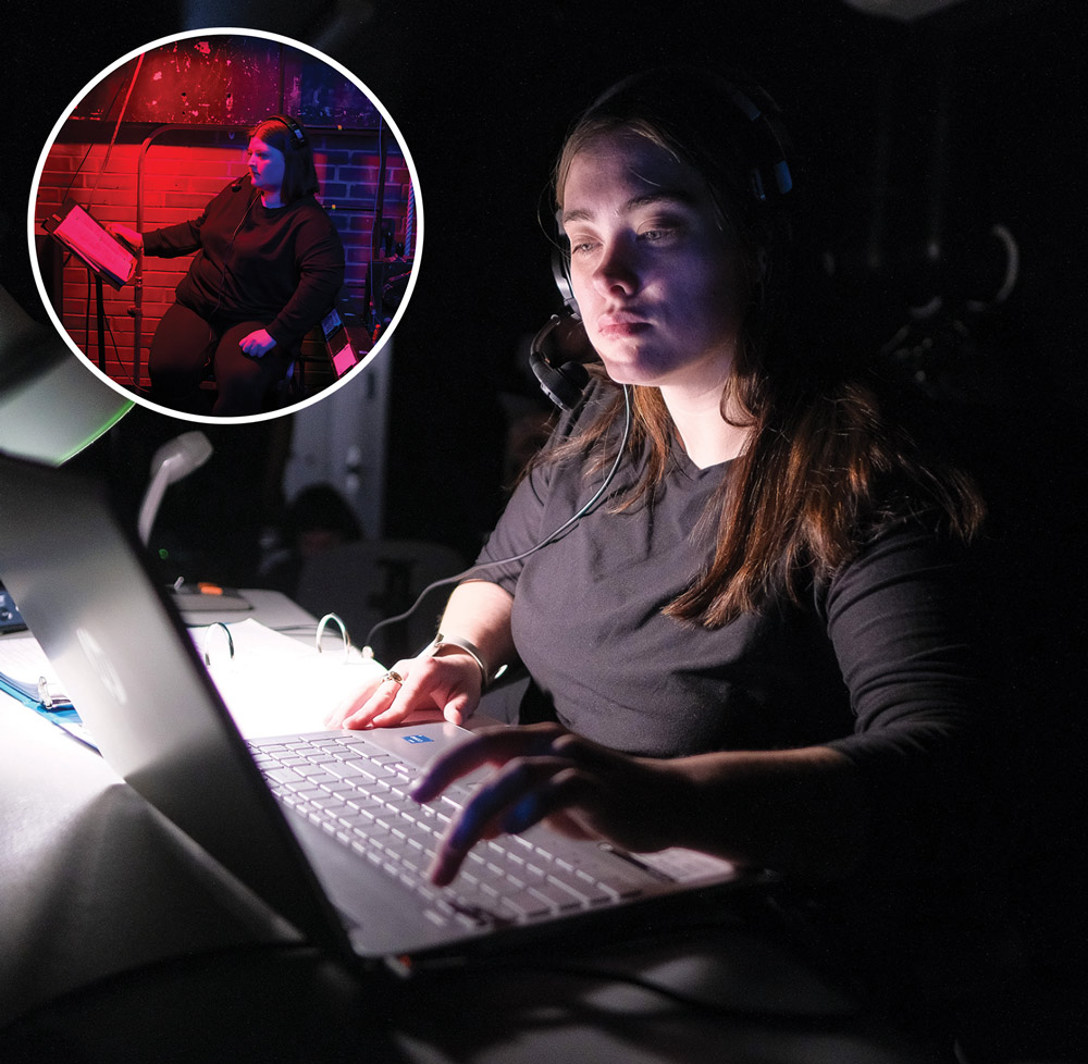 student under red light backstage with headset on while seated; Stage manager Brittany Walsh communicating with crew during laptop
