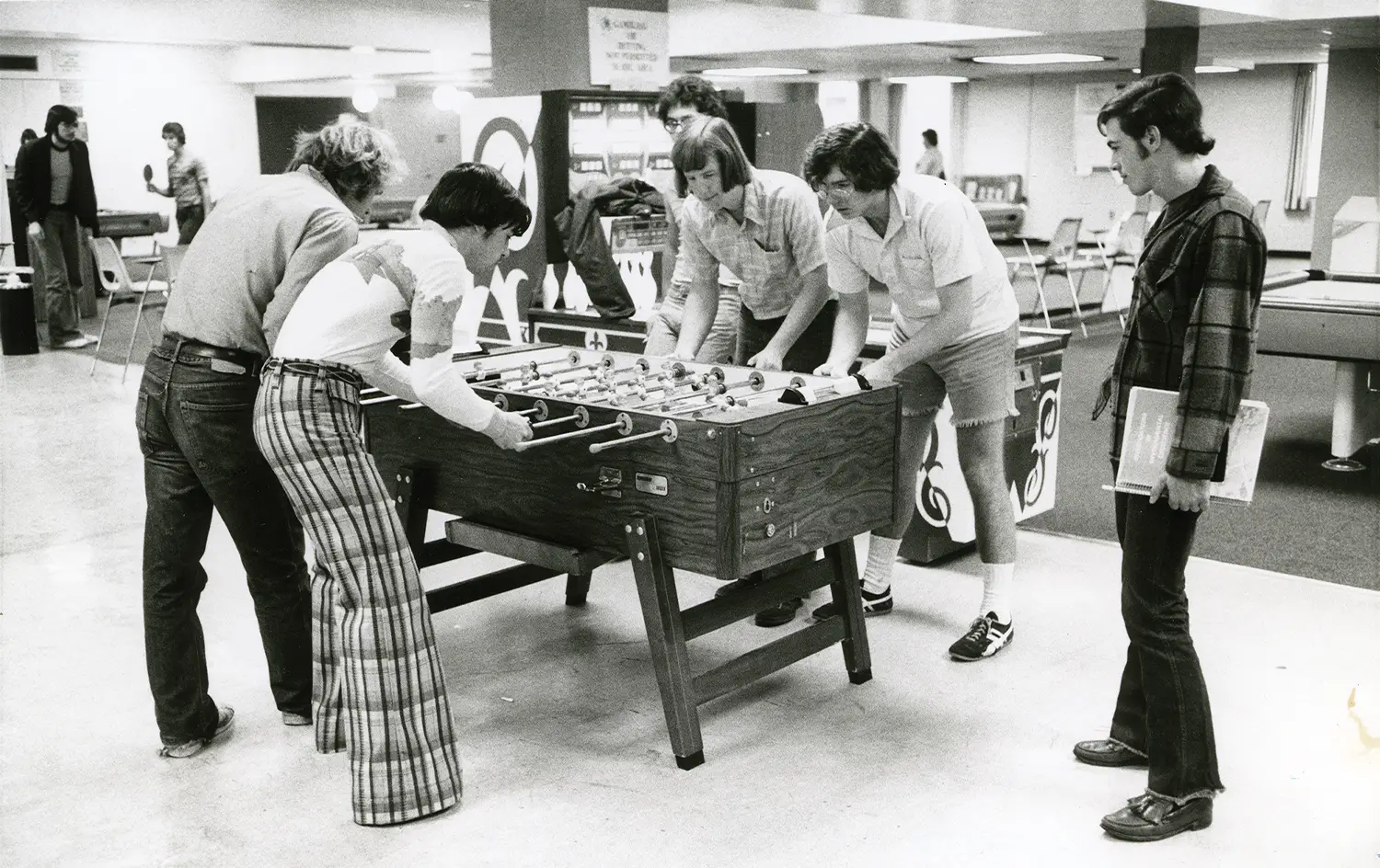 black and white photo of students playing foosball in the early 1970s