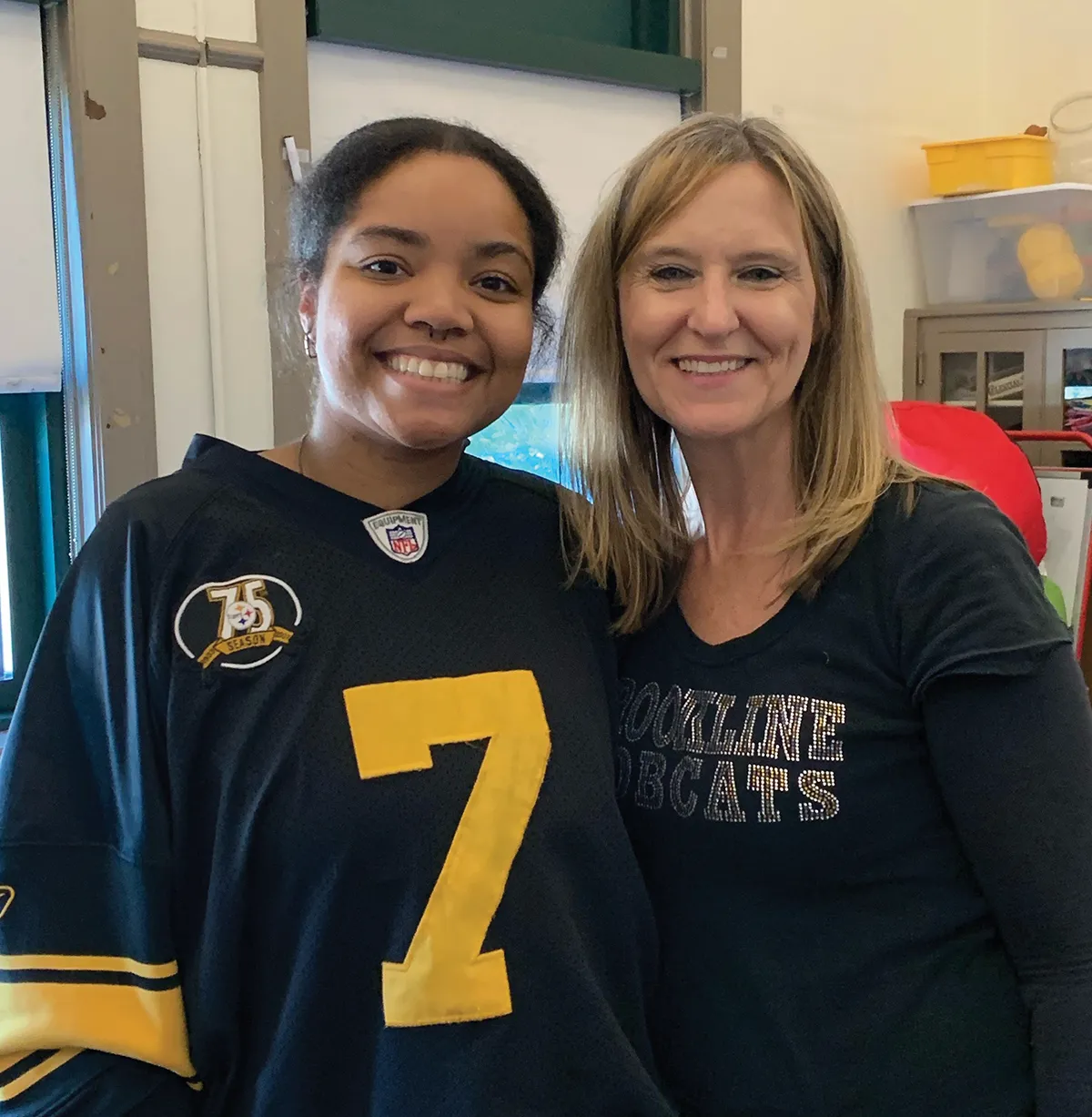 Elsie Eason with Gina Murphy, wearing a black and yellow sports jersey with the number 7, the other a 'Rockline Bobcats' t-shirt