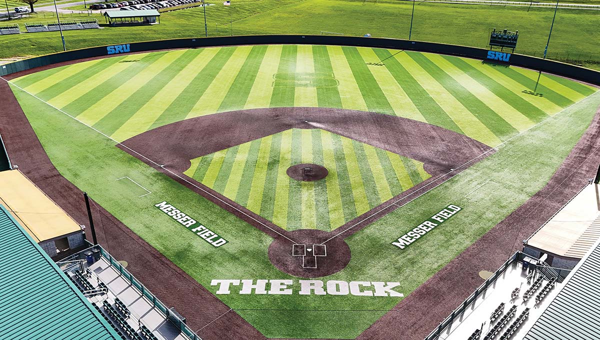 SRU baseball field on a bright, sunny day showing THE ROCK with MESSER FIELD emblazoned along both the first and third-baseline foul territories